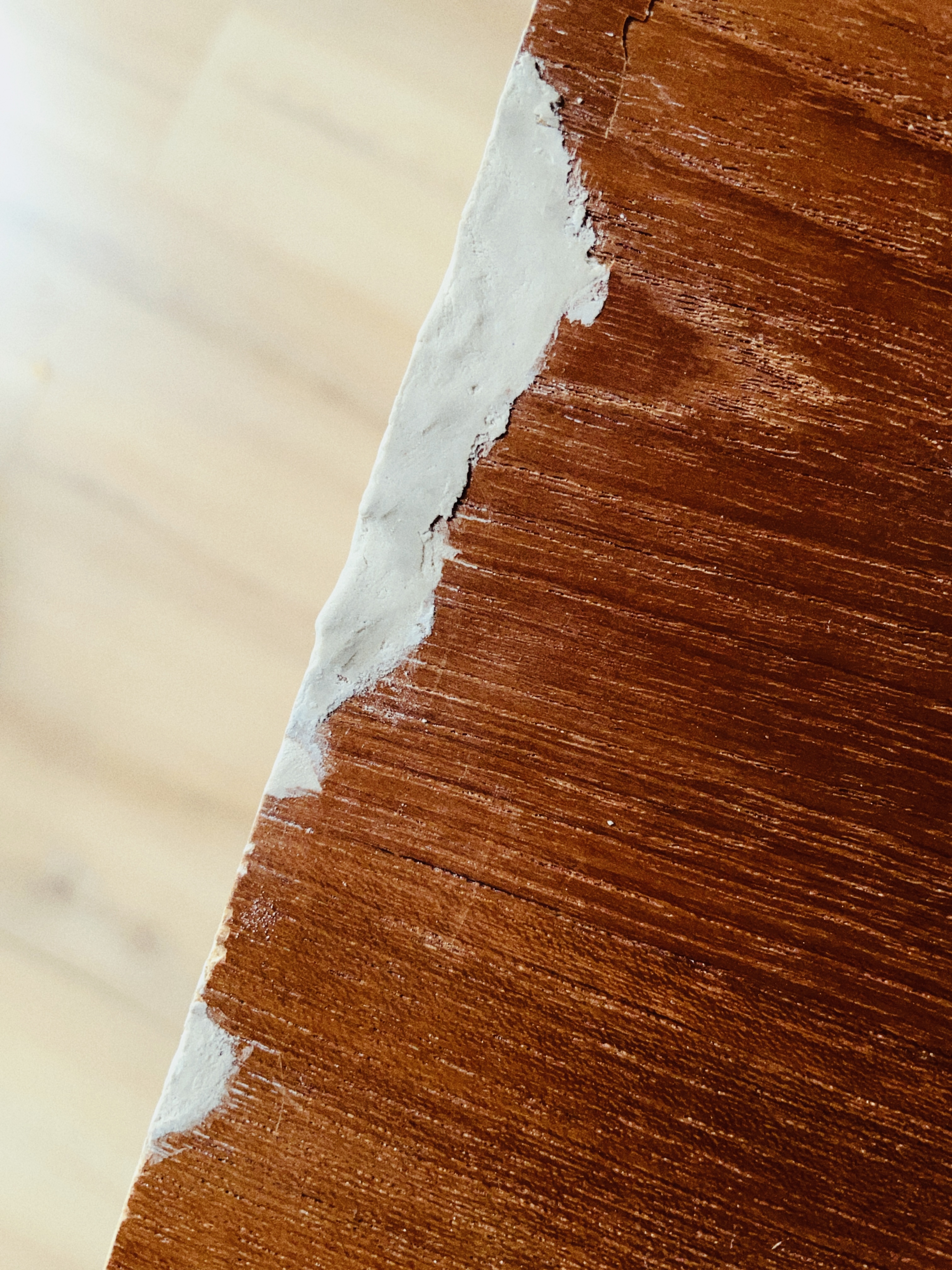 I spent this morning working on the cabinet. It turned out that wood filler is all but impossible to apply evenly. But the result is good enough for me (no one would see it anyway). The most important thing it stops further damage.

Also, the wood filler tube says "Brown color". Some needs to have their eyes checked.