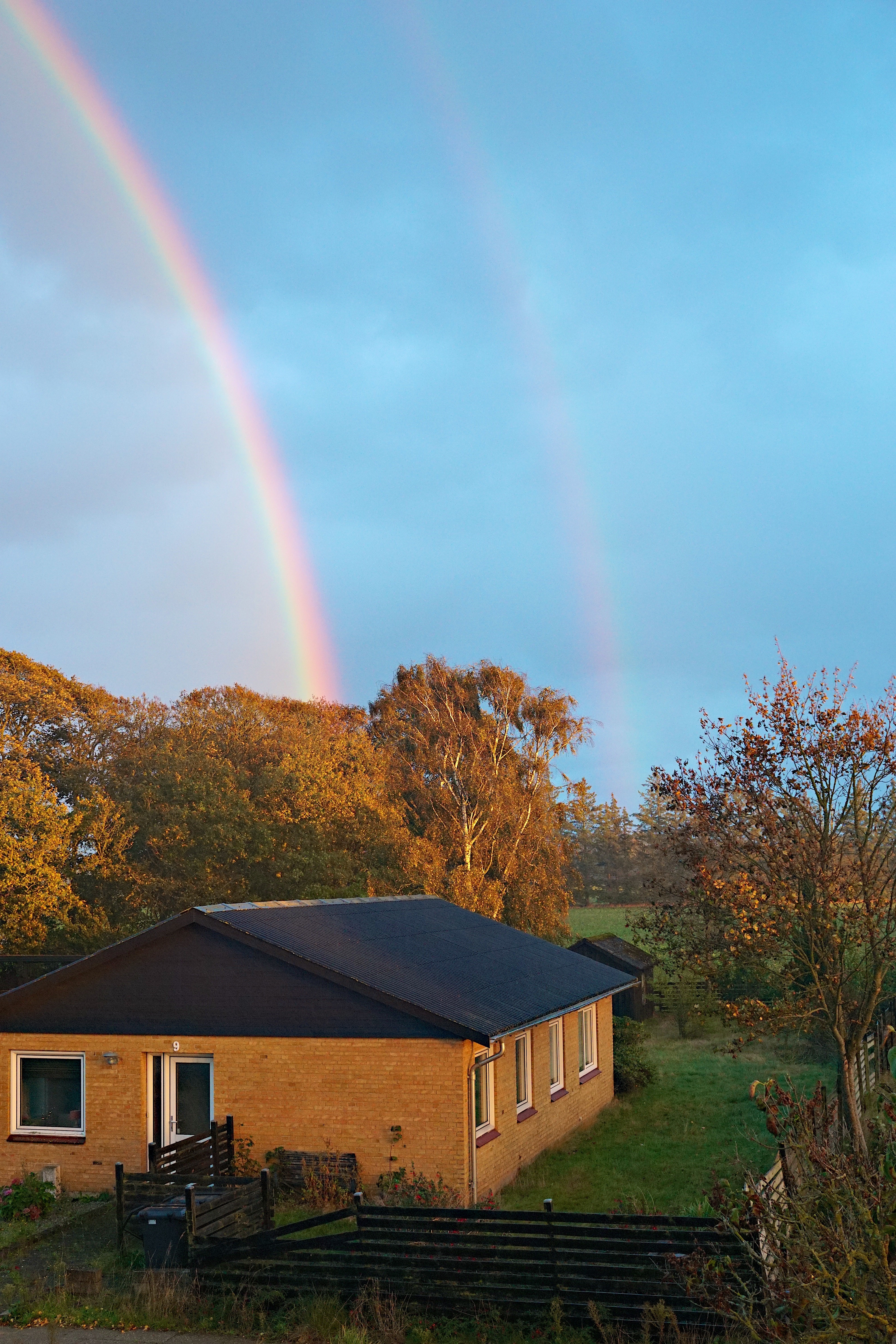 We've had terrible weather today. But for a very brief moment, we were treated to the most amazing full double rainbow. I had just enough time to capture a handful of hasty snapshots before the rainbow dissolved into grayness.