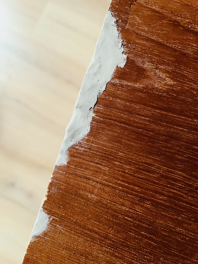 I spent this morning working on the cabinet. It turned out that wood filler is all but impossible to apply evenly. But the result is good enough for me (no one would see it anyway). The most important thing it stops further damage.

Also, the wood filler tube says "Brown color". Some needs to have their eyes checked.