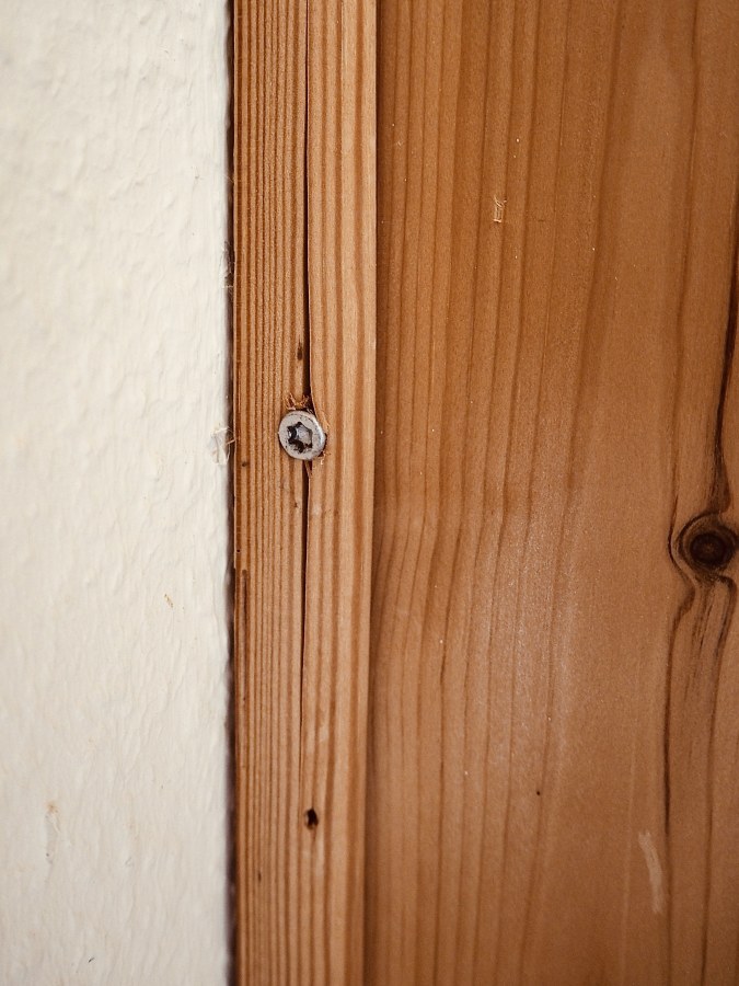 1/3 It pains me to see so much shoddy work in our house. It feels like everything was done by someone who hates their job and royally sucks at it. I mean, why would you a) use the right screw, b) pre-drill a hole so the wood won't split, or c) drive the screw in straight, when you can do the exact opposite?

If I ever meet the son of a bitch who did this, I'll hit his toe with a hammer so hard he'll forget his own mother's name.