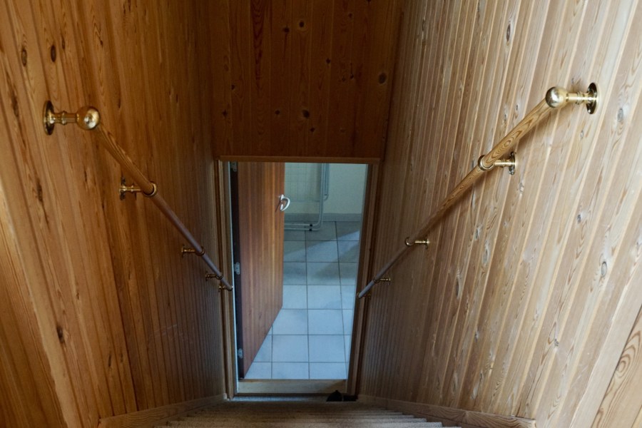 At this point, we've pretty much resigned ourselves to the fact that most of the work in the house was done by a madman. But even so, there are some things that leave us scratching our heads. Case in point: the pictured staircase to the upper floor. You probably can't see it, but the handrails are not the same length. What's worse is that if the left handrail were the same length, it could have been screwed perfectly into the wooden plank. Instead, it was screwed into the seam between two planks, splitting one of them in the process.